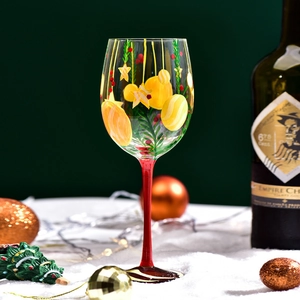Hand-painted Christmas tree wine glass with festive ornaments and red stem design