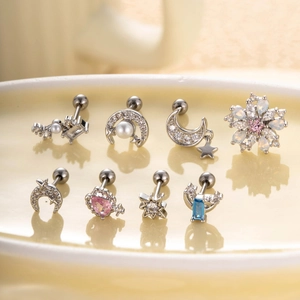 Star and moon stud earrings with zircon inlay on a ceramic tray display