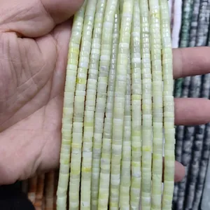 Detailed close-up of natural light green cylindrical spacer beads for DIY jewelry making