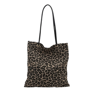 Large leopard print tote bag with black slim straps and metallic gold eyelets on white back
