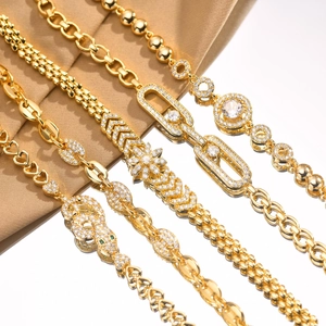 Detailed view of gold plated bracelets with heart, flower, and zircon stone designs