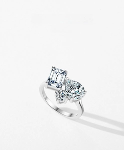 Detailed macro view of S925 sterling silver ring with emerald, pear, and round cut stones