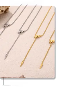 Close-up of minimalist gold and silver snake bone necklaces with geometric slide buckles