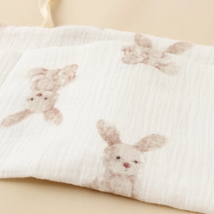 Close-up of soft double-layer cotton gauze fabric with cute brown rabbit pattern prints