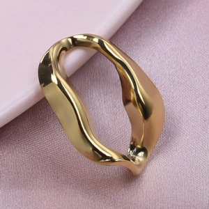 Macro detail of a 18k gold-plated irregular twisted ring with a glossy liquid design