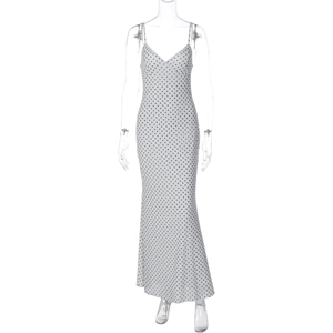 Detailed view of the deep V-neckline and polka dot pattern on the French style dress