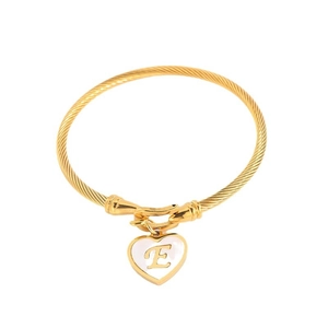 Golden twisted cable bracelet with a white heart charm featuring a gold letter E detail