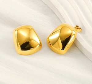 Macro shot of minimalist gold geometric square earrings with a high-polished mirror finish