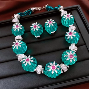 Détails d'un ensemble collier et boucles d'oreilles argentés avec pierres roses