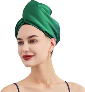 Close-up of a green satin hair bonnet for long hair, showing smooth silky texture detail