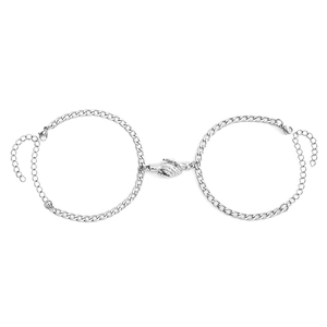 Detail of silver chain couple bracelets with magnetic handshake clasp on white background