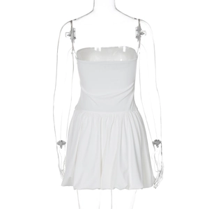 Detail view of the white strapless dress back featuring elastic waist and pleated hem