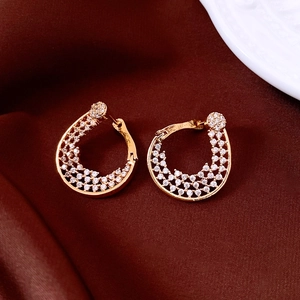 Detail of 18K gold-plated twisted flower earrings with sparkling pavé zircons on red silk