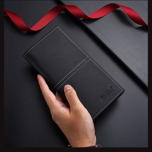 Detailed view of black textured leather wallet with white contrast stitching and logo