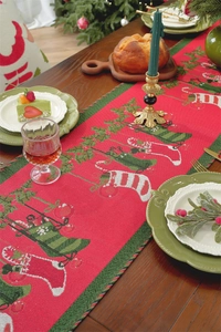 Detailed jacquard Christmas table runner with festive stocking and gift box patterns