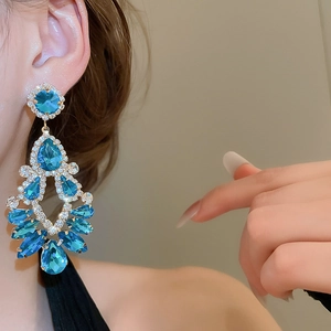 Macro shot of chandelier drop earrings with sapphire blue crystals and sparkling tassels