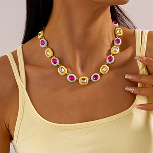 Detail of colorful geometric pendant necklace with pink rhinestones on a female model