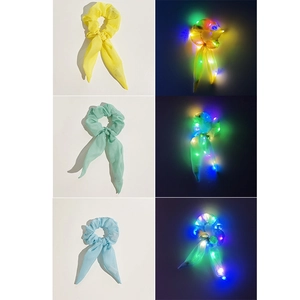 Detail of LED glowing hair scrunchies with long ribbons in yellow mint and blue colors