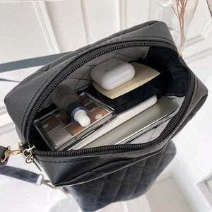 Black quilted crossbody bag for women showing spacious interior with daily essentials