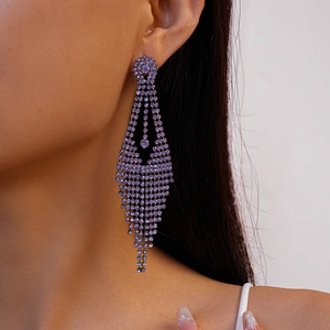 Detail of purple rhinestone tassel earrings showing the elegant fringe and silver pin