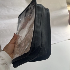 Close-up of durable black jewelry organizer bag with transparent PVC window and zipper