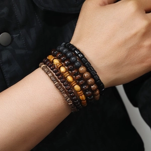 Detail of multi-layer handmade wooden beads bracelet set with coconut shell textures