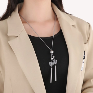 Long stainless steel necklace with transparent crystals and metallic tassel pendants