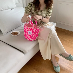 Detail of pink leopard print canvas tote bag with woven label and soft inner lining
