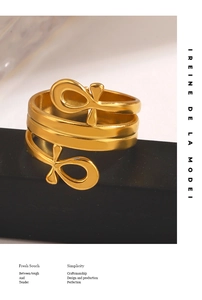 Detail of 18K gold-plated multi-layer spiral ring featuring unique circular cross ends
