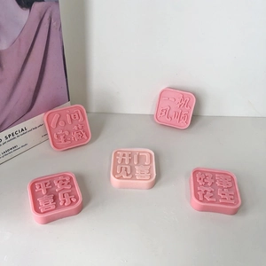 Detailed view of pink square resin molds with Chinese lucky characters for DIY candles