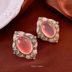 Vintage rhine-stoned rhombic earrings with pink oval stones on brown silk fabric