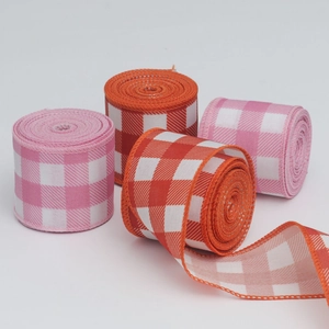 Close-up of pink and orange linen-style plaid Christmas ribbons with wired edges