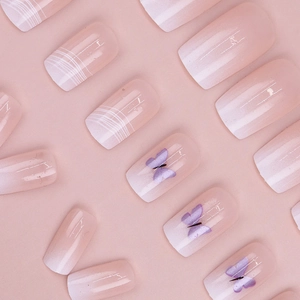 Detailed view of pink white ombre press-on nails with purple butterfly and glossy finish
