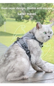 Detail of gray reflective cat harness vest showing secure buckles on a wood deck