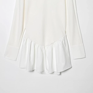 White batwing sleeve patchwork dress with elegant ruffled hem on light grey background