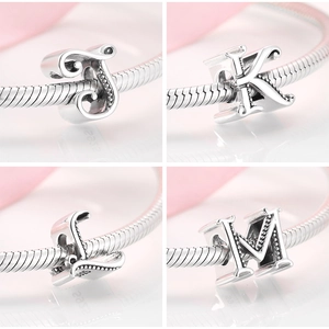 Detailed view of S925 sterling silver alphabet charms J K L M on a snake chain bracelet