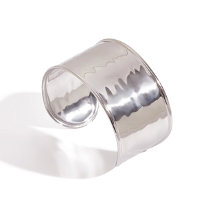 Polished silver wide open cuff bracelet with hammered metal texture from 45-degree angle