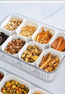 Detailed macro view of an 8-compartment transparent storage box with white drainage liners
