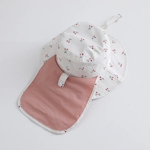 Macro detail of kids sun hat with cherry print and pink neck protection flap