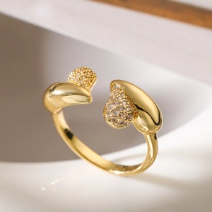 Macro view of gold plated open ring with geometric patterns and sparkling zircon stones