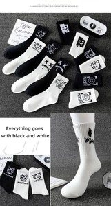 Detailed knit texture of black and white cotton crew socks with street style graffiti