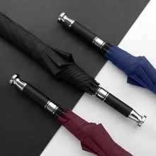 Detail of premium business umbrellas with metallic handles in black, navy, and burgundy colors