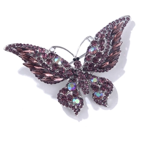 Detail of vintage butterfly brooch with purple crystals and AB gems on silver base