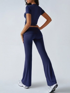 Rear view of deep blue yoga set with slim fit short sleeve top and flare pants