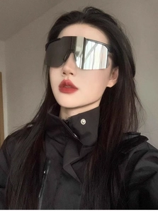 Silver oversized shield cycling sunglasses worn with streetwear for a trendy look
