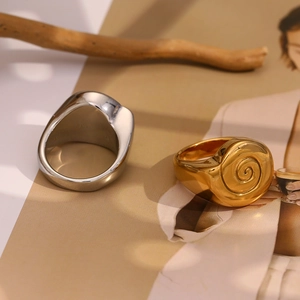Detailed view of the 18K gold-plated shell-shaped ring with spiral texture details