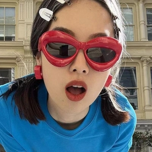 Chic red oversized cat-eye sunglasses with matching earrings for a stylish trendy look