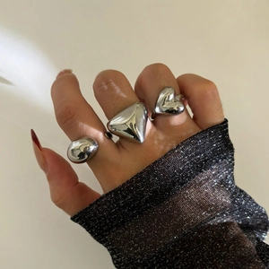 Three-piece silver stainless steel ring set with heart and geometric shapes on a hand