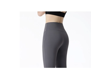 Close-up of cross high waist design on dark grey yoga pants for tummy control