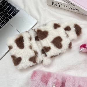 Detailed shot of the soft plush heart-patterned coin pouch with zipper closure
